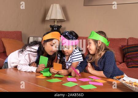 Girls playing with cards and colored chips Stock Photo