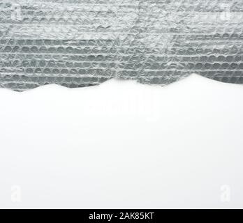 fragment of a transparent film with air for transportation of parcels is glued on gray polyethylene, inside of the envelope Stock Photo