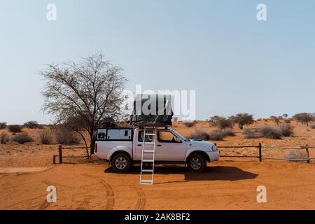 Tent located on the roof of a pickup 4x4 car in a desert camp Stock Photo