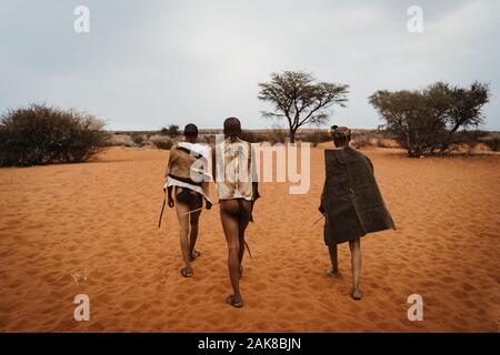 original native bushman from Namibia with traditional clothing from behind Stock Photo