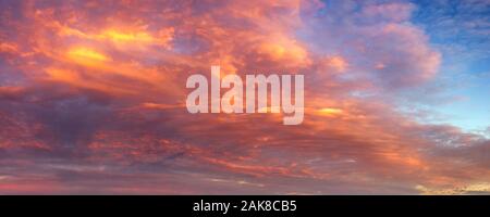 beautifully lit clouds during sunrise Stock Photo