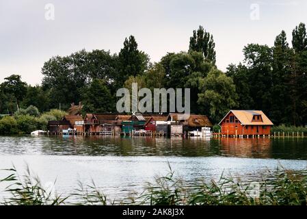 Old wooden cottages on the lake shore in Schwerin, Germany. Stock Photo
