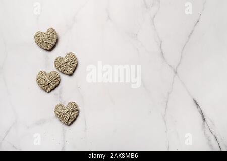 Zero waste, Valentine's Day eco-friendly concept. Hearts with yarn on white marble background. Copy space for text or design. Top view or flat lay Stock Photo