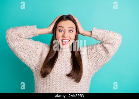 Portrait of astonished crazy girl hear incredible news bargain scream shout wear knitted pullover isolated over teal turquoise color background Stock Photo