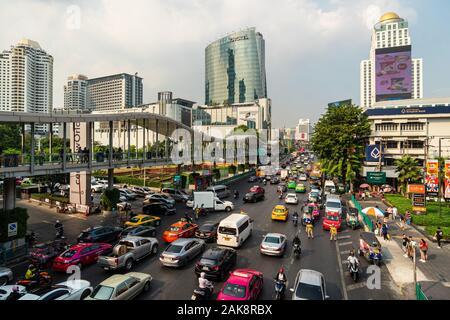 Bangkok, Thailand - December 24 2019: Heavy traffic rushes along the Ratchadamri road in the heart of Bangkok downtown shopping district in Thailand c Stock Photo