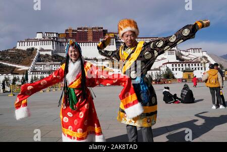 (200108) -- LHASA, Jan. 8, 2020 (Xinhua) -- Tourists wearing Tibetan costumes pose for photos at the Potala Palace square in Lhasa, capital city of southwest China's Tibet Autonomous Region, Jan. 1, 2019. More than 40 million tourists from home and abroad visited southwest China's Tibet Autonomous Region in 2019, up 19 percent year on year, according to local authorities.   In 2019, tourism revenue rose to 56 billion yuan (7.9 billion U.S. dollars), Qizhala, chairman of the regional government, said in his government work report delivered on Jan. 7, 2020 at the third session of the 11th People Stock Photo