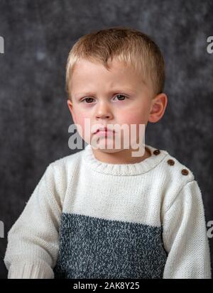 portrait of cute little boy pouting, a studio portrait Stock Photo