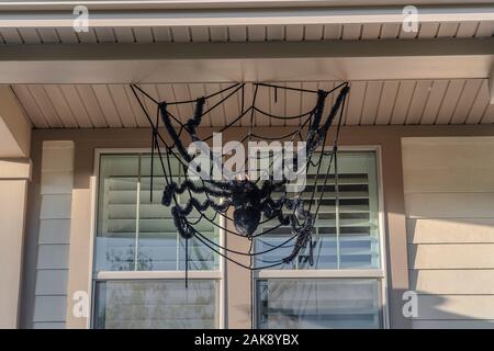 Large creepy black Halloween spider decoration on a sunny day Stock Photo