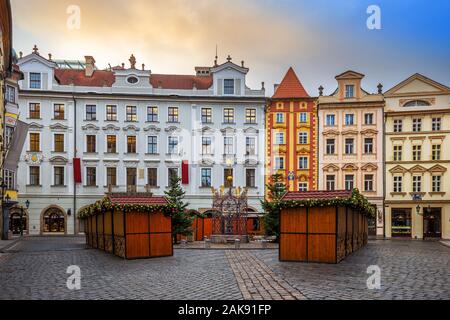 Prague, Czech Republic - Beautiful little square and traditional Czech houses of Prague with small Christmas market on a sunny afternoon. Golden cloud Stock Photo