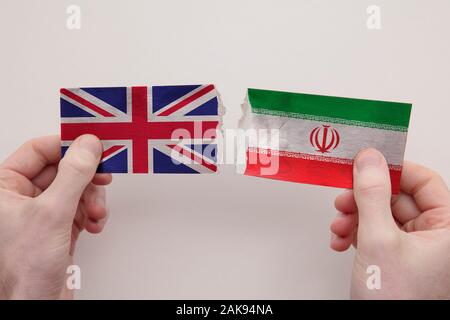 USA and Iran paper flags ripped apart. political relationship concept Stock Photo