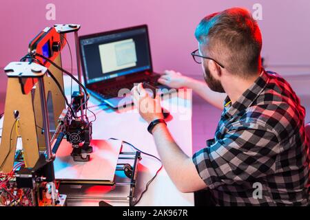 A student man print prototype on 3D printer. Stock Photo