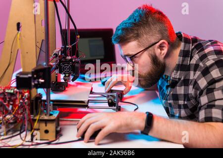 A student man print prototype on 3D printer. Stock Photo
