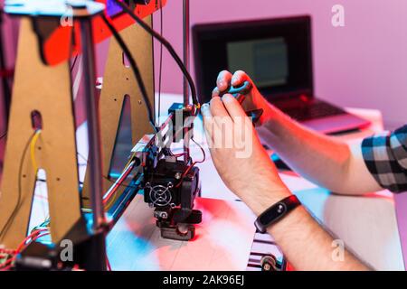 A student man print prototype on 3D printer. Stock Photo
