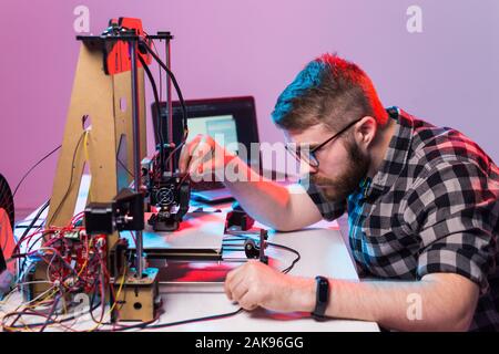 A student man print prototype on 3D printer. Stock Photo