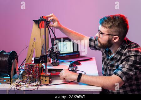 A student man print prototype on 3D printer. Stock Photo