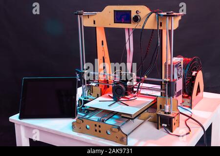 Electronic three dimensional plastic printer during work in school laboratory, 3D printer, 3D printing. Stock Photo