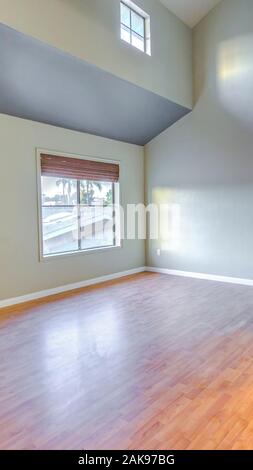 Vertical frame Two story master bedroom with wood floors Stock Photo