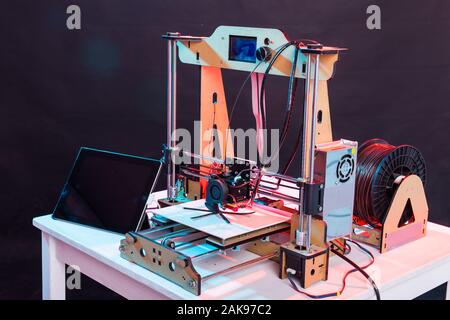 Electronic three dimensional plastic printer during work in school laboratory, 3D printer, 3D printing. Stock Photo