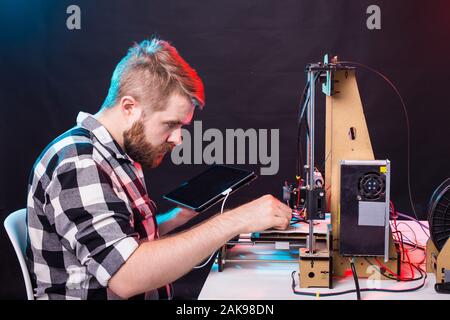 A student man print prototype on 3D printer. Stock Photo
