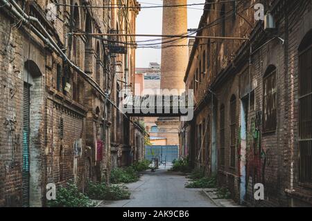 Alley of an old abandoned factory. Stock Photo