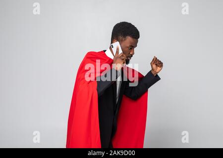 Young african businessman run and talking on the phone isolated on white background Stock Photo