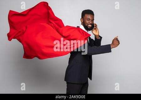 Young african businessman run and talking on the phone isolated on white background Stock Photo