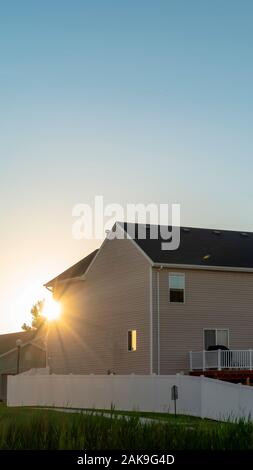 Exterior view of lovely homes with bright sun and blue sky background ...