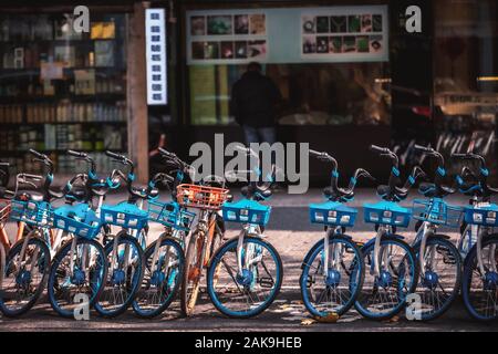 Rental electric bikes parked on the sidewalk, Hangzhou Stock Photo