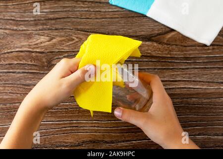 Festive table setting. The child adds a flower from napkins. Handmade. Project of children's creativity, handicrafts, crafts for kids. Stock Photo