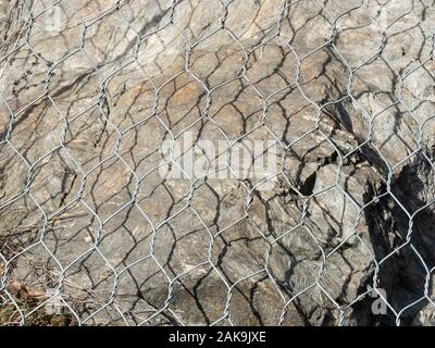 detail of metal mesh used to protect mountain roads from landslide and rockfall Stock Photo