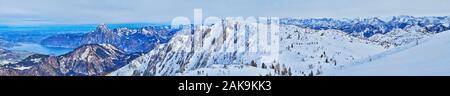 Spectacular panorama of Salzkammergut Alps, covered with pure white snow and bright blue surface of Traunsee lake on the background, Ebensee, Austria Stock Photo