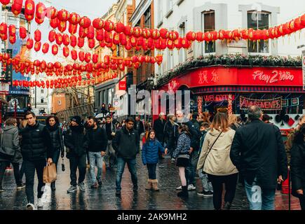 London, UK/Europe; 20/12/2019: Chinatown street full of chinese red lanterns, shops, restaurants and people walking and shopping. Soho district in Lon Stock Photo