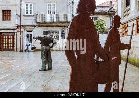 Pontevedra, Galicia, Spain : A man walk past the The Fiel Contraste sculpture by artist Ramón Conde inaugurated in 2010 at Alhondiga street in the old Stock Photo