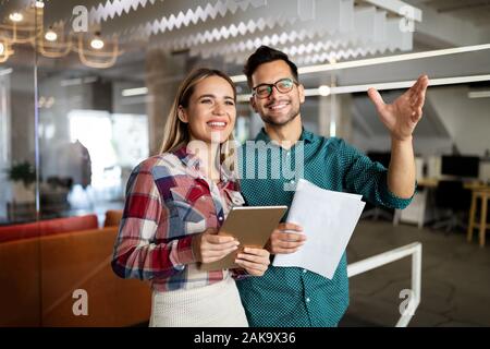 Successful company with happy employees in modern office Stock Photo