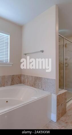 Vertical Modern luxury fitted bathroom interior in home Stock Photo