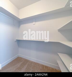 Square frame Empty white shelves inside a walk in cupboard Stock Photo