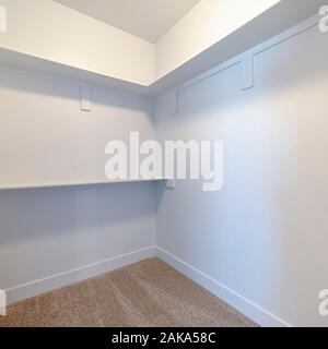 Square frame Empty white shelves inside a walk in cupboard Stock Photo