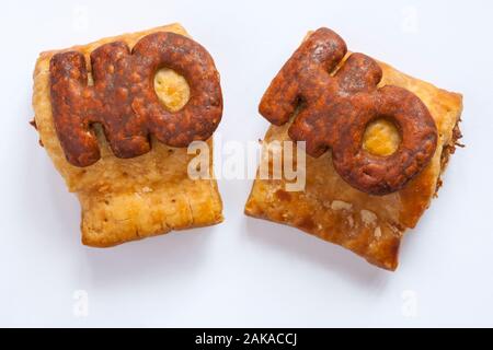Two M&S Handcrafted Sausage Rolls isolated on white background - Ho Ho - looking down on from above Stock Photo