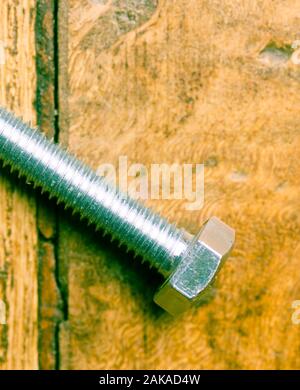 Close up of M8 bolt isolated on wooden background Stock Photo