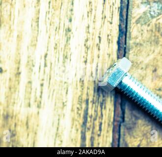 Close up of M10 bolt isolated on wooden background Stock Photo
