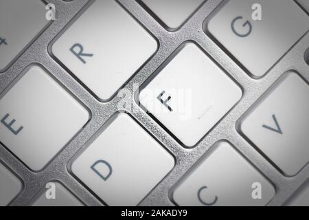 Keyboard - silver portable computer keyboard in IT department with letter F isolated on white button Stock Photo