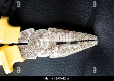 Old rusty pliers closeup on a black background Stock Photo