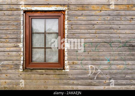 A wooden window in a wall made of logs Stock Photo