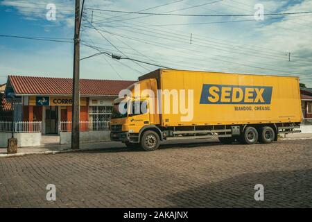 Sedex truck, an express delivery service from the Brazilian Postal Service, near a post office in Cambara do Sul. A tourist town in southern Brazil. Stock Photo