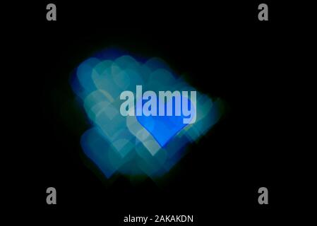 Abstract light, blue bokeh pattern in heart shape. St Valentides Day or Holiday concept, background image. Stock Photo