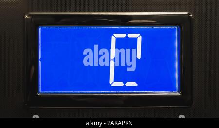 broken blue LCD display showing 0 in an elevator Stock Photo