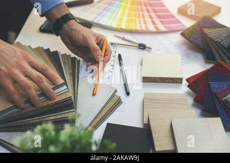 designer choosing flooring and furniture materials from samples for home interior design project Stock Photo