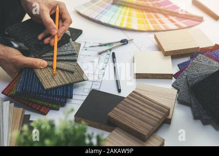 designer choosing flooring and furniture materials from samples for home interior design project Stock Photo