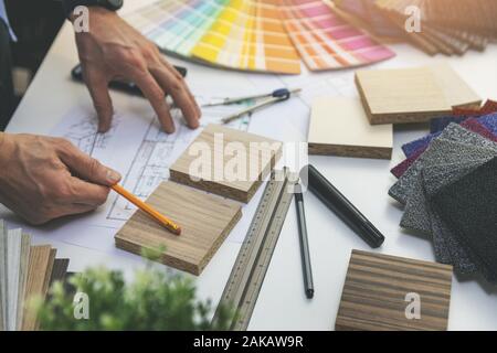 designer choosing flooring and furniture materials from samples for home interior design project Stock Photo