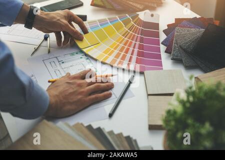 designer choosing paint color from swatch for home interior design project Stock Photo
